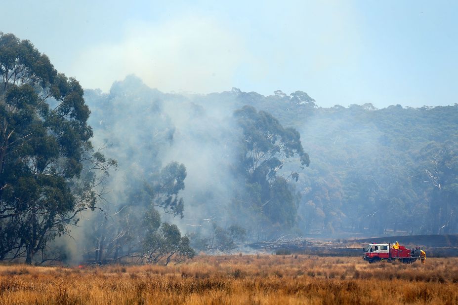 Firefighters attack a fire from the ground on Wednesday, January 9, in Bungendore, Australia. A "catastrophic warning" was lifted, but the fire risk was still considered "severe" in the northeastern part of New South Wales. The threat has eased as temperatures have fallen in the southern Australian state, but authorities warn the danger isn't over yet.