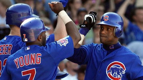 Chicago Cubs slugger Sammy Sosa, right, is congratulated at the plate by his teammates after scoring in a game against the San Francisco Giants on August 10, 2001, at Wrigley Field in Chicago.