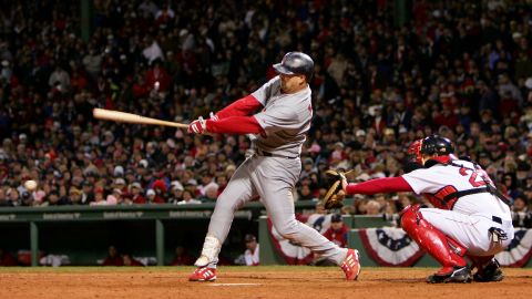 Larry Walker of the St. Louis Cardinals hits an RBI double in the sixth inning against the Boston Red Sox during Game One of the 2004 World Series on October 23, 2004, at Fenway Park in Boston.
