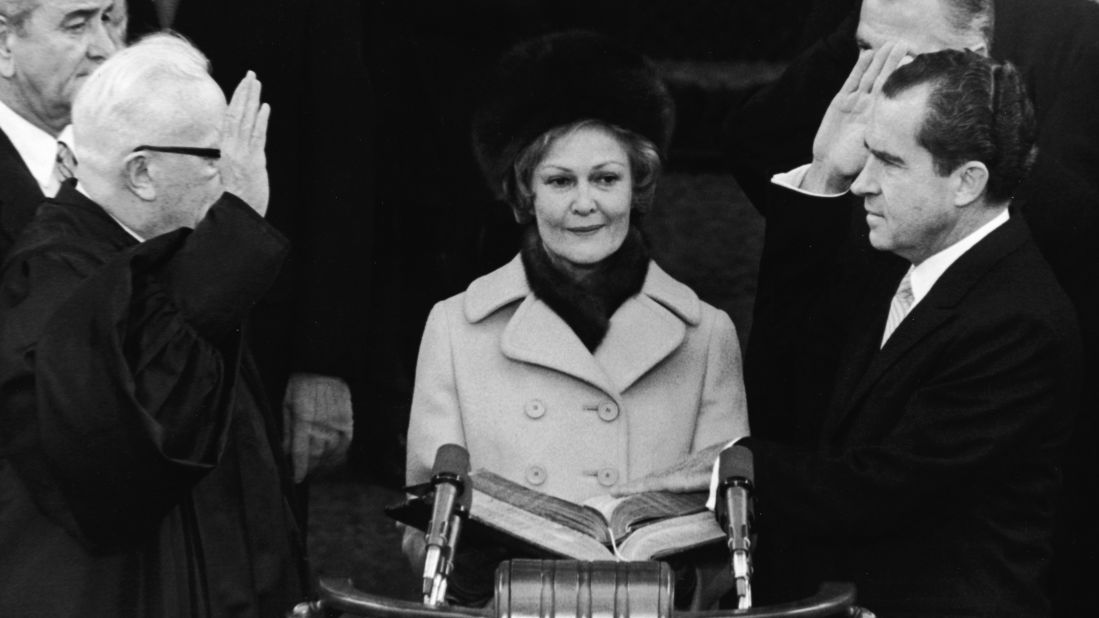 First lady Pat Nixon, center, watches as her husband is sworn in as the 37th president of the United States by Supreme Court Chief Justice Earl Warren on January 20, 1969.