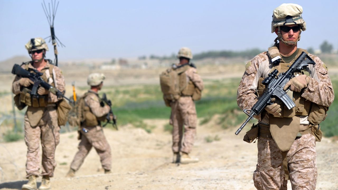 US Marines from Kilo Company of the 3rd Battalion 8th Marines Regiment head out on patrol in Garmser, Helmand Province, last June. 