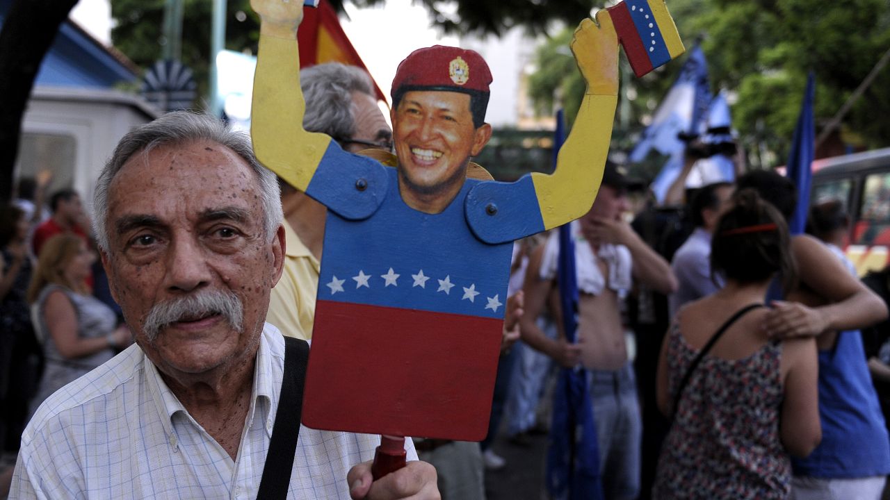 A man holds a figurine of Venezuelan President Hugo Chavez during a rally in support of his recovery in front of the Venezuelan embassy in Buenos Aires on January 8, 2013. The President of the National Assembly Diosdado Cabello announced today that due to health reasons, Chavez will not be able to take the oath to be sworn in for a fourth term in office next January 10. A constitutional fight intensified with the government planning a massive show of support in the streets on the day he is supposed to be sworn in. Chavez, who underwent his fourth round of cancer surgery in Havana nearly a month ago, is suffering from a severe pulmonary infection that has resulted in a respiratory insufficiency. AFP PHOTO / ALEJANDRO PAGNI (Photo credit should read ALEJANDRO PAGNI/AFP/Getty Images) 