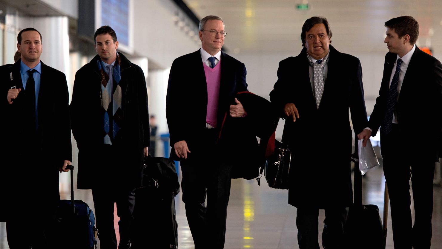 Google chairman Eric Schmidt, center, arrives at Beijing airport from North Korea on January 10, 2013.