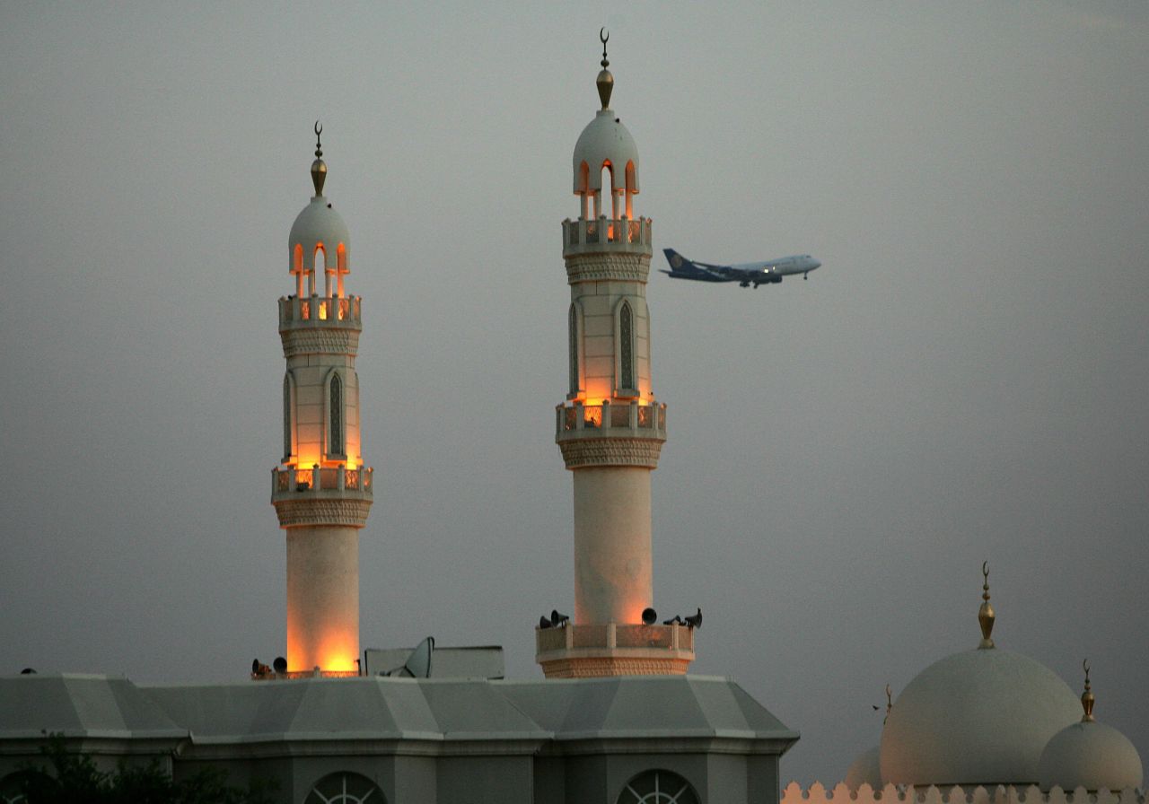 Modern and traditional: A plane flies over minarets in Dubai.