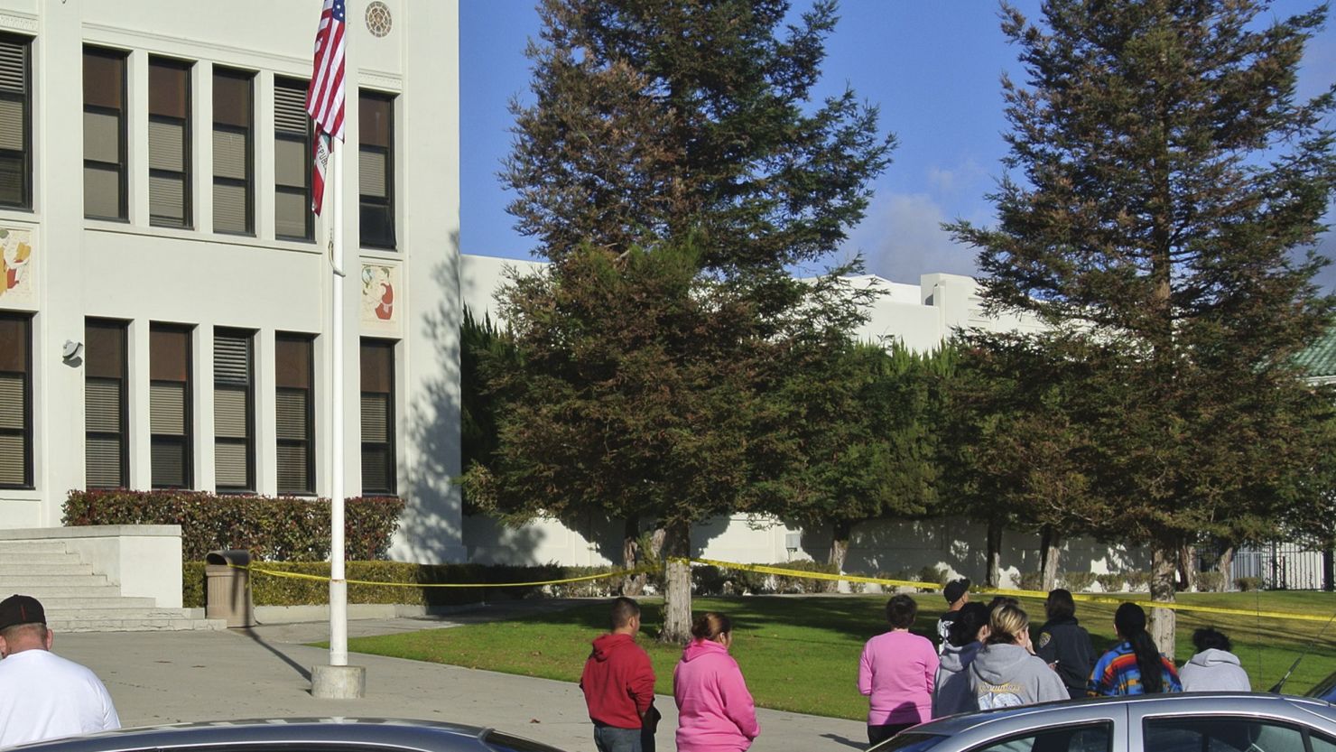 Bystanders wait outside police tape in front of Taft Union High School after a shooting incident on January 10.
