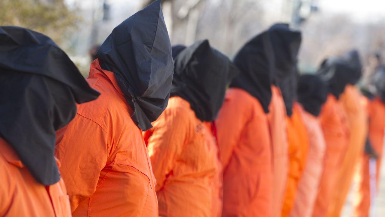 Wearing prison jumpsuits and hoods, protesters on January 8 on Capitol Hill demand the Guantanamo prison be closed.