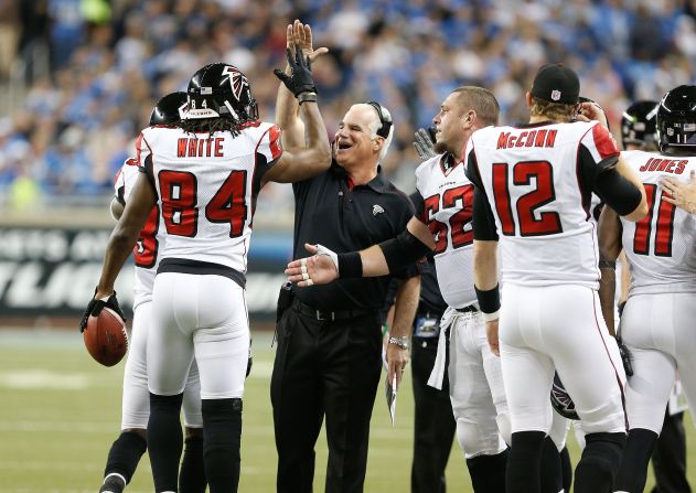Falcons head coach Mike Smith high-fives Roddy White after his second quarter touchdown while playing the Detroit Lions last month.