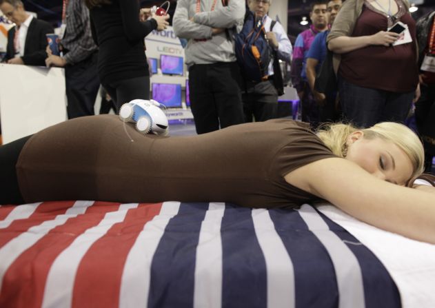 A massage robot rolls along a woman's back at the show on January 10.
