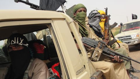 A photo taken on August 7 shows fighters of the Islamic group Ansar Dine standing guard at Kidal airport, northern Mali. 