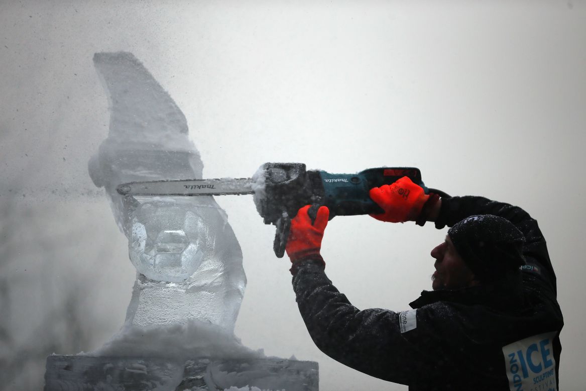  A contestant uses a chainsaw to model his ice sculpture at The London Ice Sculpting Festival at Canary Wharf on January 11 in London. Timed competitions between ice-sculpting teams from Africa, France, Hungary, Netherlands, Portugal and the United Kingdom are taking place over the three-day event.<br />