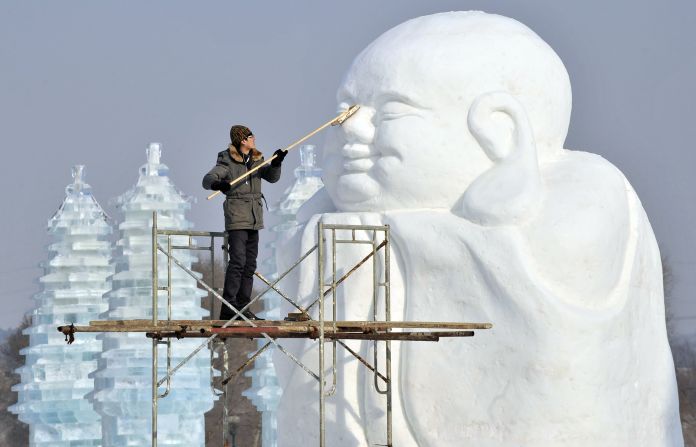 A man polishes a snow sculpture in preparation for Shenyang International Ice and Snow Festival in Liaoning province, China, on Tuesday, January 8.