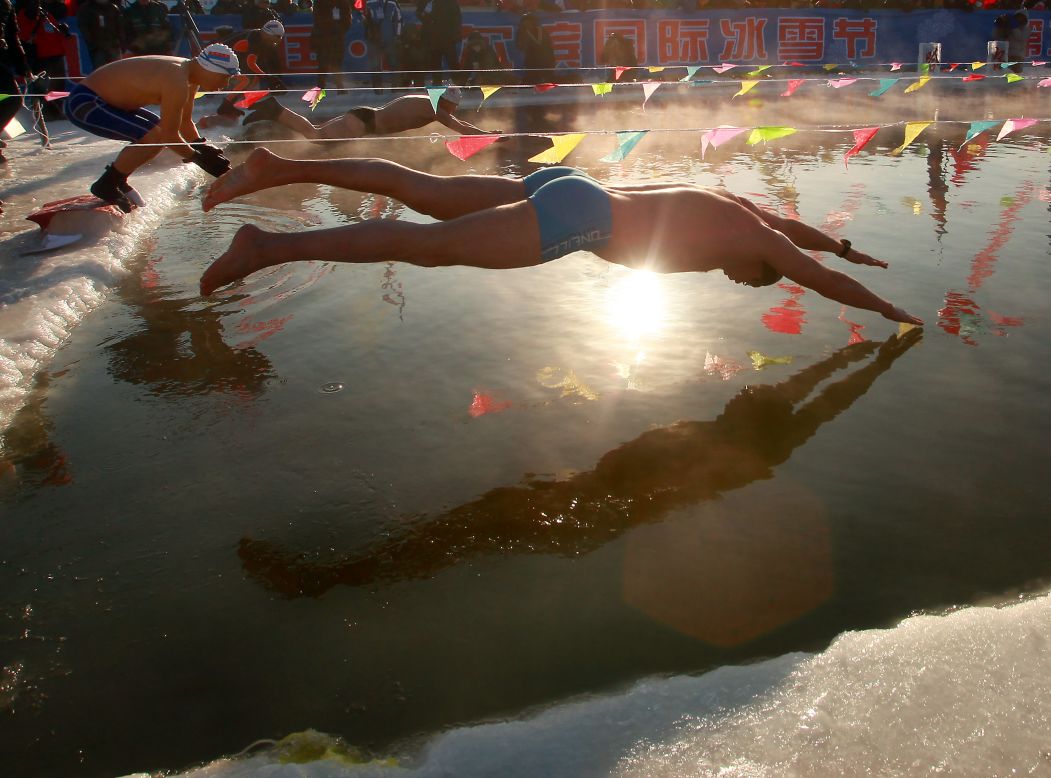 Russian and Chinese swimmers compete in the annual winter swimming competition during the Harbin festival on Thursday, January 10.   