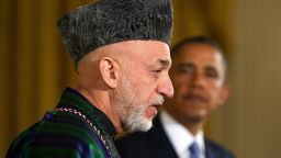 US President Barack Obama (R) listens as Afghanistan President Hamid Karzai (L) speaks during a joint press conference at the White House in Washington, DC, January 11, 2013. Karzai said Friday that he would stand down at the end of his term in 2014, as foreseen by Afghan law, and allow a successor to be elected.