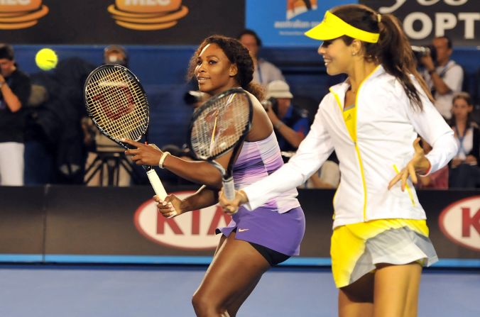 Brisbane title winner Serena Williams (L) watches a volley by Ana Ivanovic of Serbia (R) as they take part in a Kids Day exhibition match in Melbourne on January 12. 