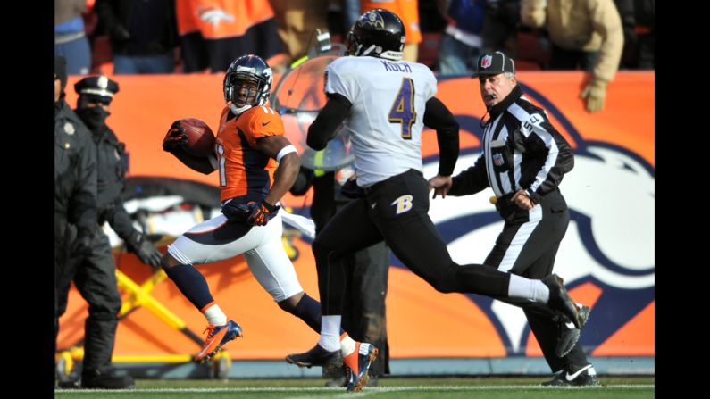 Denver's Trindon Holliday runs past Baltimore punter Sam Koch on a 90-yard touchdown return in the first quarter.