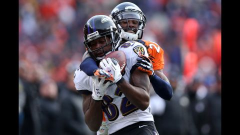 Ravens receiver Torrey Smith can't make the catch on a pass as he is wrapped up Denver's Champ Bailey.