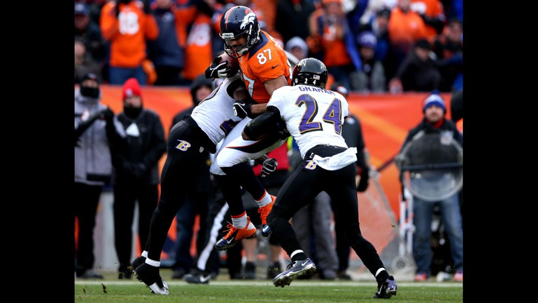 Eric Decker of the Broncos is tackled after making a reception in the second quarter against Ed Reed and Corey Graham of the Ravens.