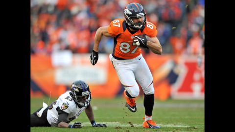 Denver's Eric Decker runs for yardage after the catch against Baltimore's Chykie Brown.