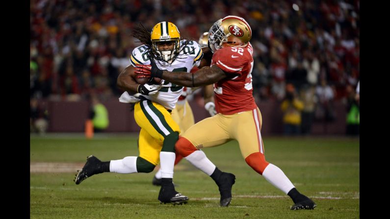 Running back DuJuan Harris of the Packers runs the ball inside linebacker Patrick Willis of the 49ers on Saturday.