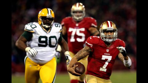 Quarterback Colin Kaepernick of the 49ers runs the ball against nose tackle B.J. Raji of the Packers on Saturday.
