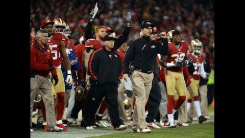 Head coach Jim Harbaugh of the 49ers celebrates a field goal at the end of the second quarter against the Packers on Saturday.