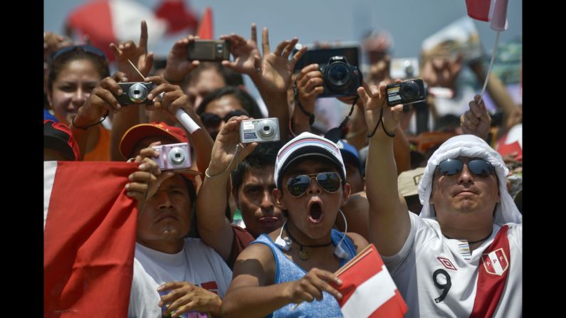 Peruvian fans take pictures of the podium during the departure ceremony on January 5.