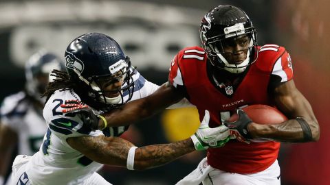 Falcons receiver Julio Jones tries to avoid the tackle of Earl Thomas of the Seahawks on Sunday.