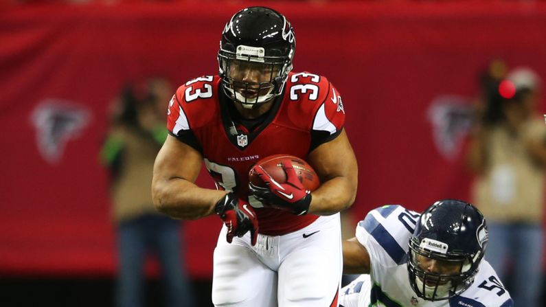 Michael Turner of the Falcons tries to avoid the tackle of K.J. Wright of the Seahawks in the first quarter on Sunday.