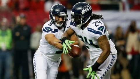 Russell Wilson hands the ball off to Marshawn Lynch of the Seahawks in the second quarter against the Falcons on Sunday.