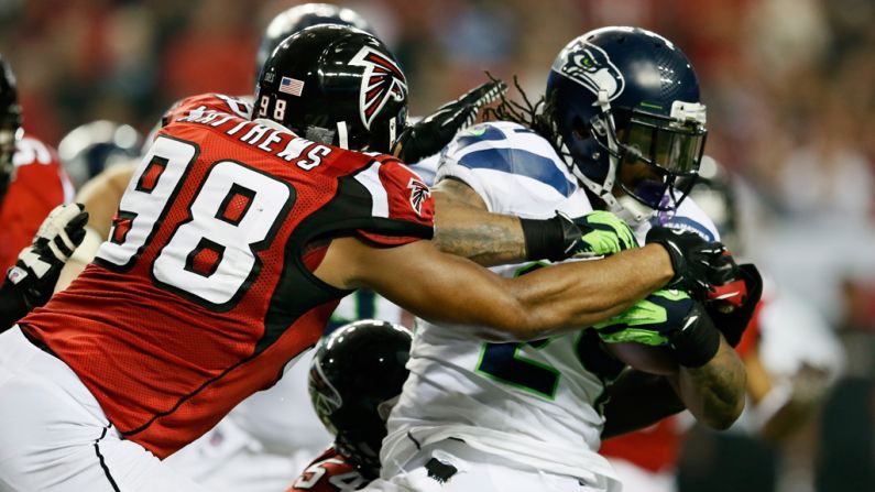 Cliff Matthews of the Falcons tackles Marshawn Lynch of the Seahawks on Sunday.
