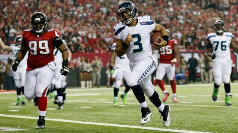 Russell Wilson of the Seahawks runs the ball in for a fourth quarter touchdown against the Falcons on Sunday.