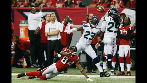 Earl Thomas of the Seahawks intercepts a pass intended for Roddy White of the Falcons in the fourth quarter on Sunday.
