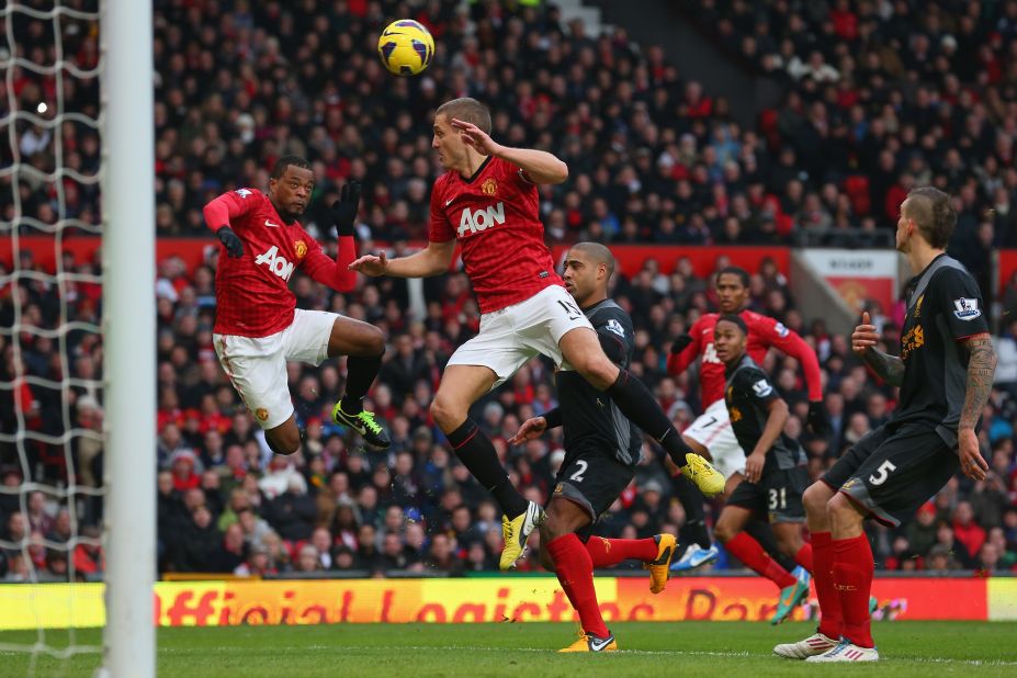 Nemanja Vidic was credited with Manchester United's winning goal against Liverpool after he inadvertently deflected a header by teammate Patrice Evra, left, past goalkeeper Pepe Reina.