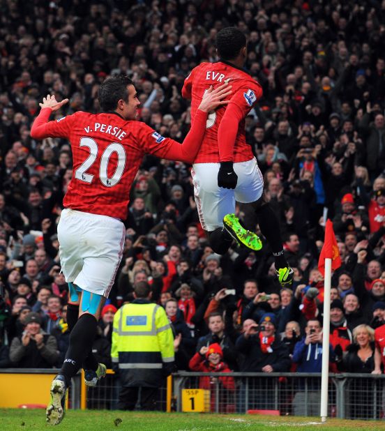Evra, right, celebrates the goal with United's top scorer Robin van Persie at Old Trafford, as Alex Ferguson's team retained a seven-point lead in the English Premier League.  