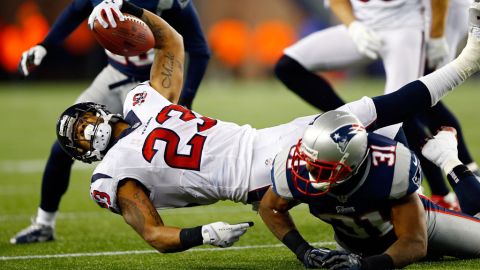 Arian Foster of the Houston Texans stretches for a first down against the Patriots on Sunday.