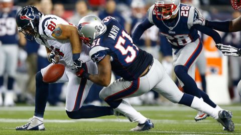 Jerod Mayo of the New England Patriots knocks the ball away from Owen Daniels of the Houston Texans after it was ruled his forward progress was stopped.