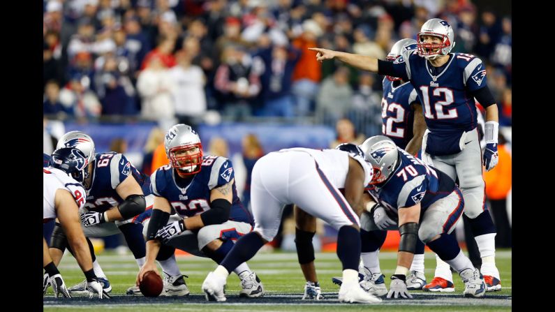 Patriots quarterback Tom Brady makes an adjustment during Sunday's game against the Houston Texans.