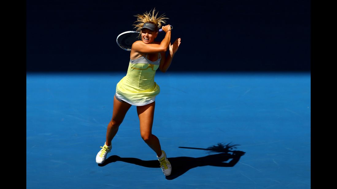 Russia's Maria Sharapova plays a backhand in her first-round match against Russia's Olga Puchkova on the first day of the Australian Open. 