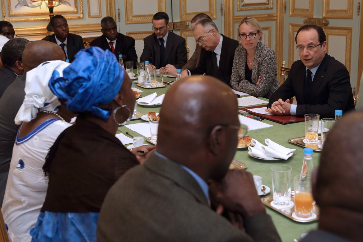French President Francois Hollande, right, speaks with members of Malian associations in France during a meeting at the Elysee Palace in Paris on Sunday.