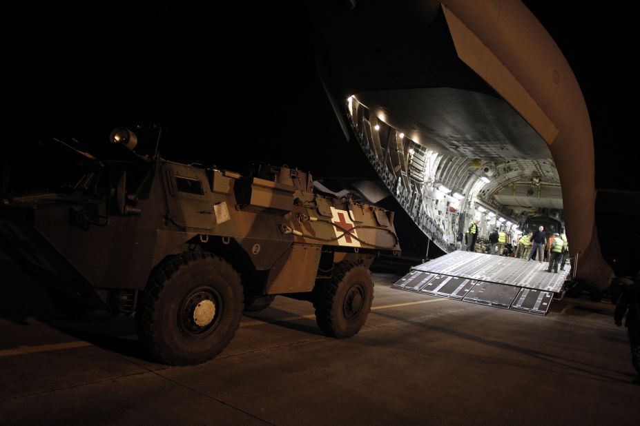 A French armored vehicle rolls onto a British army aircraft to be taken to Bamako on Sunday in Evreux.