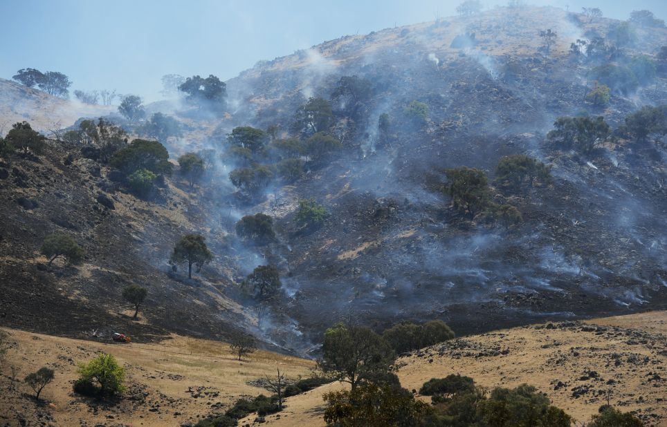 A scrub fire burns up a hillside south of Bookham near Yass on Friday.