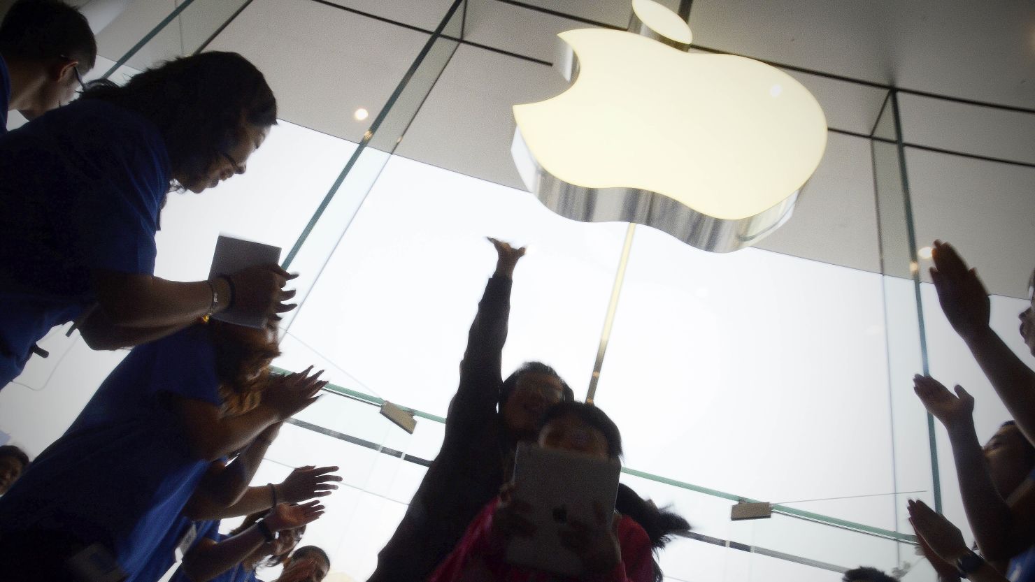 Apple staff welcoming customers in the new Apple store at WangFujin business district in Beijing on October 20, 2012. 