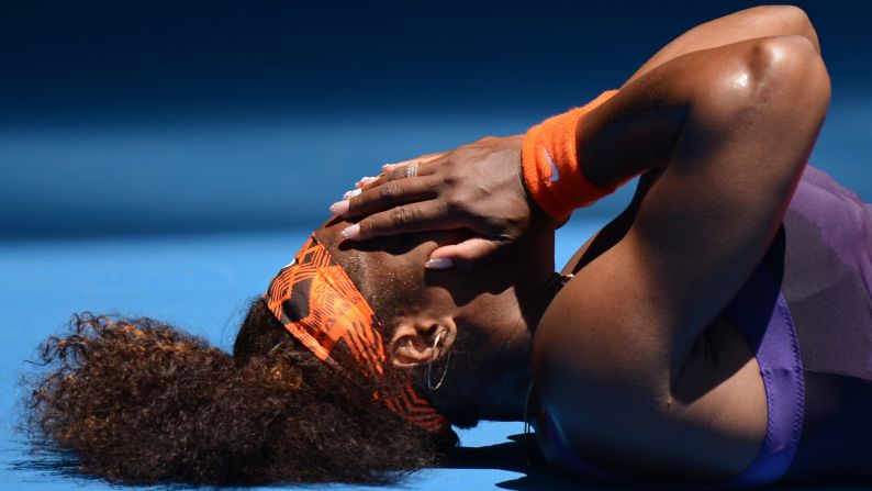Serena Williams of the United States falls to the court during her first-round match against Romania's Edina Gallovits-Hall on January 15.