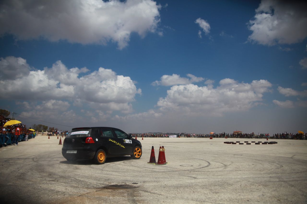 Marah Zahalka taking a turn during a race in Bethlehem. Palestinian street car races, held at makeshift venues such as airfields, often attract 1,000 spectators.