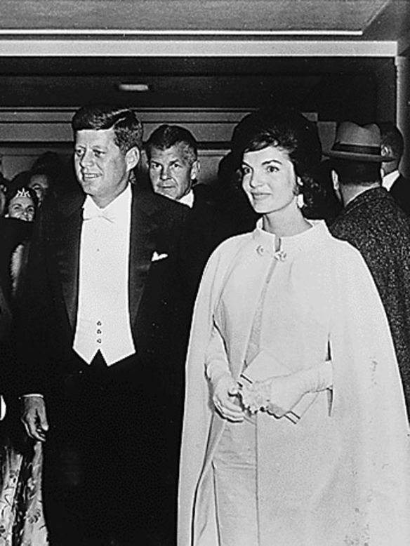 President John F. Kennedy arrives with wife Jacqueline for an inaugural ball in 1961.