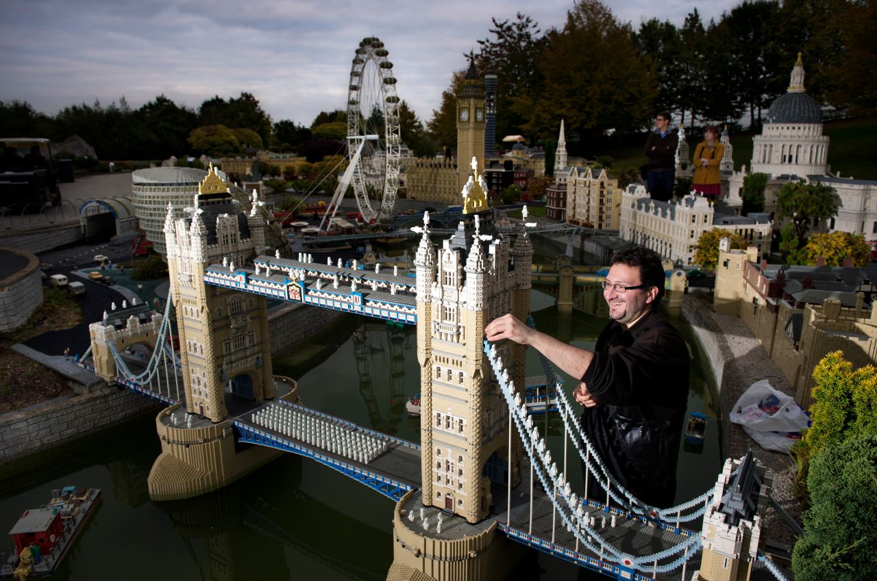 A model maker places another brick on this miniature Tower Bridge at Legoland in Windsor, London. At the hotel, rooms are pirate and adventure themed and families can eat at in-house restaurant, Bricks.