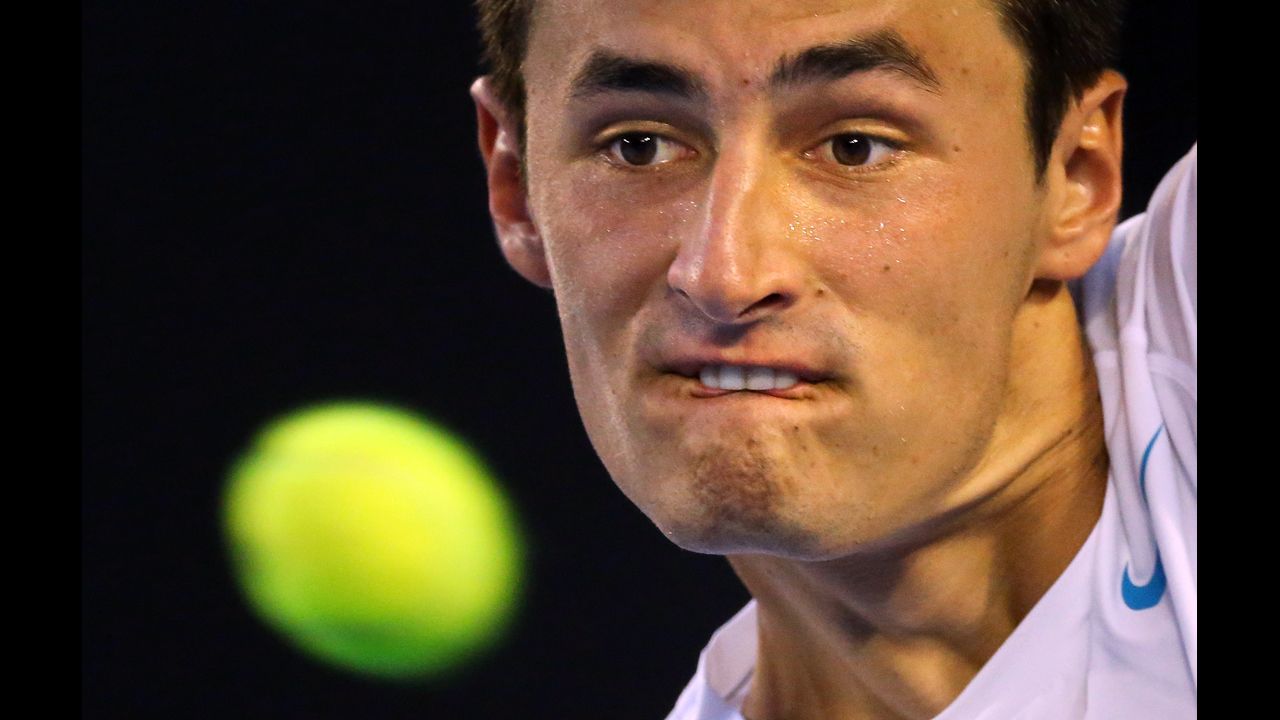 Bernard Tomic of Australia plays a backhand in his first-round match against Leonardo Mayer of Argentina on January 15. Tomic defeated Mayer 6-3, 6-2, 6-3.