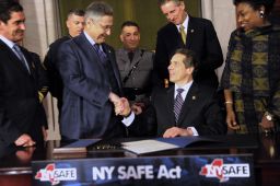 Assembly Speaker Sheldon Silver and others congratulate New York Governor Andrew Cuomo after he signed the New York Secure Ammunition and Firearms Enforcement Act at the Capitol in Albany in 2013. REUTERS/Hans Pennink 