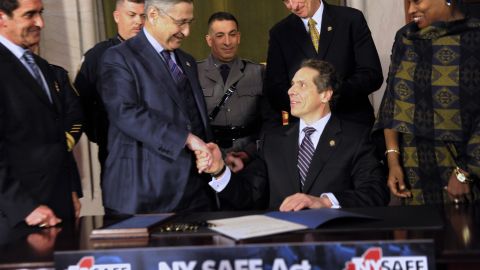 Assembly Speaker Sheldon Silver and others congratulate New York Governor Andrew Cuomo after he signed the New York Secure Ammunition and Firearms Enforcement Act at the Capitol in Albany in 2013. REUTERS/Hans Pennink