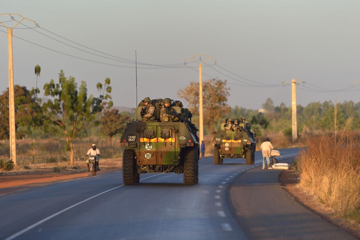 French army soldiers stand on armoured vehicles as they leave Bamako and start their deployment to the north of Mali as part of the Serval operation on Tuesday, January 15.  